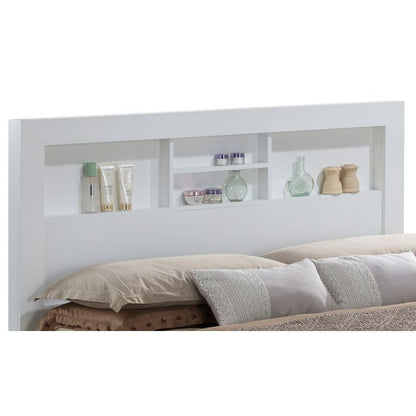 The Bed With Transitional Design Stylish features a white headboard with built-in shelves for bottles, jars, and small containers, positioned behind a bed accented with beige and gray pillows.