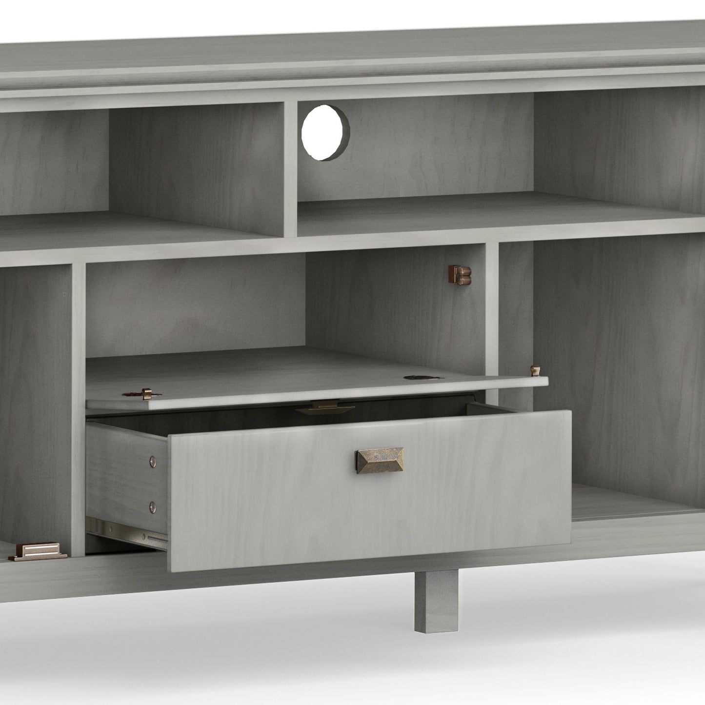 The Artisan TV Media Stand is a gray wooden unit featuring multiple open shelves, a round cable management hole on the back panel, and a centrally located drawer that's partially open.