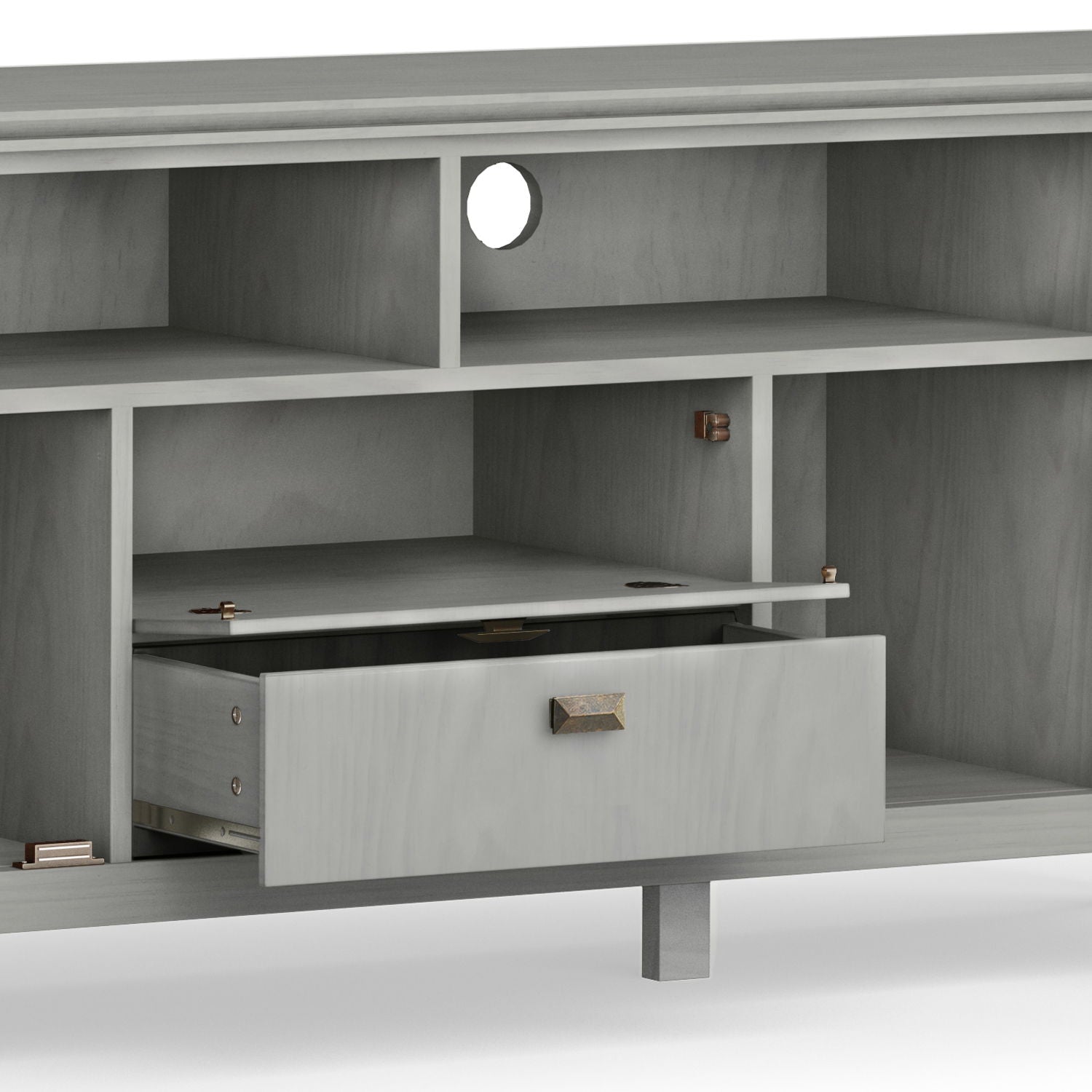 The Artisan TV Media Stand is a gray wooden unit featuring multiple open shelves, a round cable management hole on the back panel, and a centrally located drawer that's partially open.