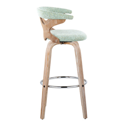 The Gardenia – Contemporary Fixed Height Barstool with Swivel features light wood legs, a round metal footrest, and an upholstered seat with a curved light green backrest; shown in profile against a white background. Set of 2.