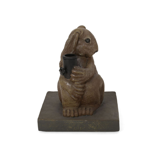 The Hand Crafted Rabbit Umbrella Base in light brown features a playful design of a rabbit sitting upright on a square base, holding an umbrella holder with both front paws.