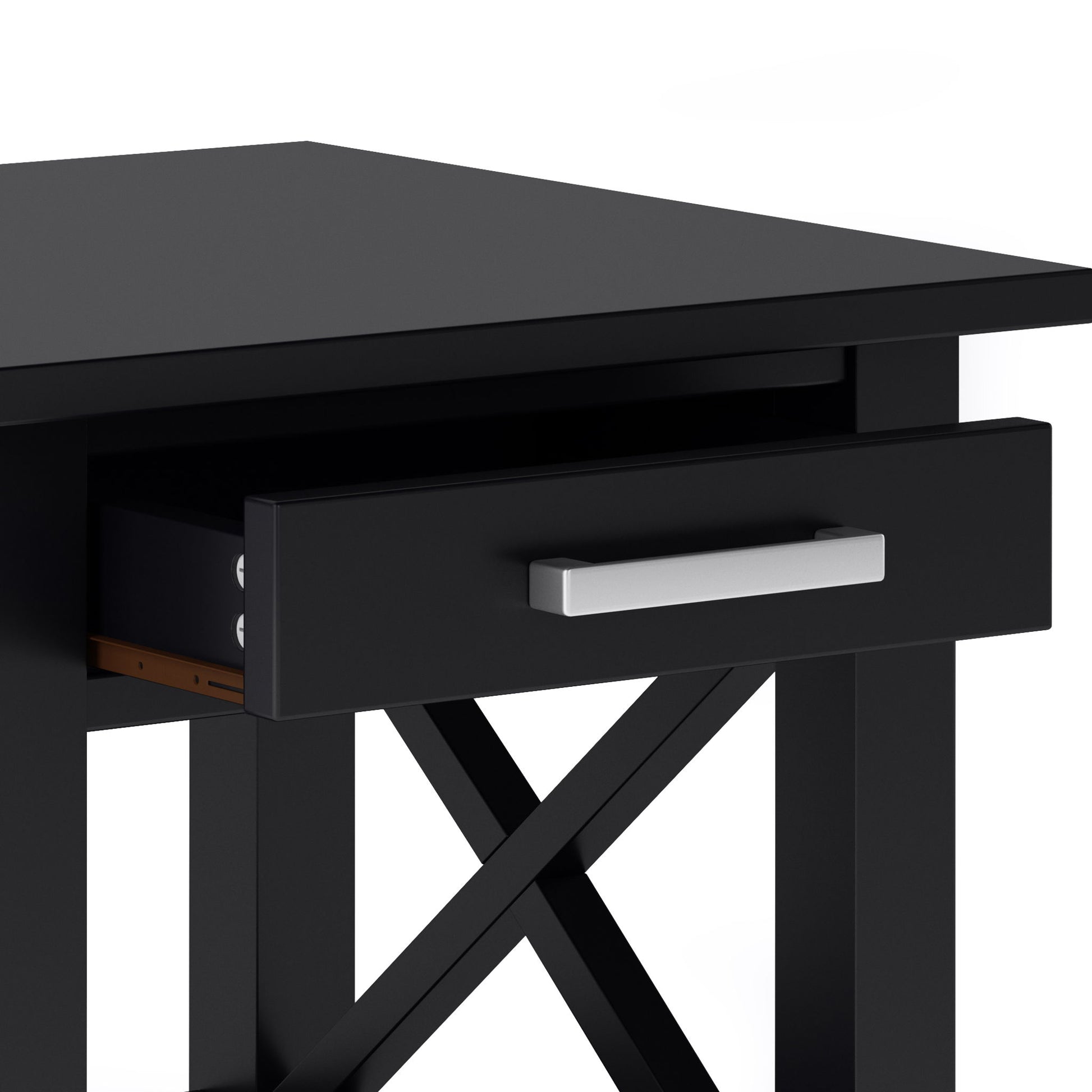 A close-up of the Kitchener - Handcrafted Table, a black wooden desk with an open drawer featuring a silver handle and crossed support beams beneath the tabletop.