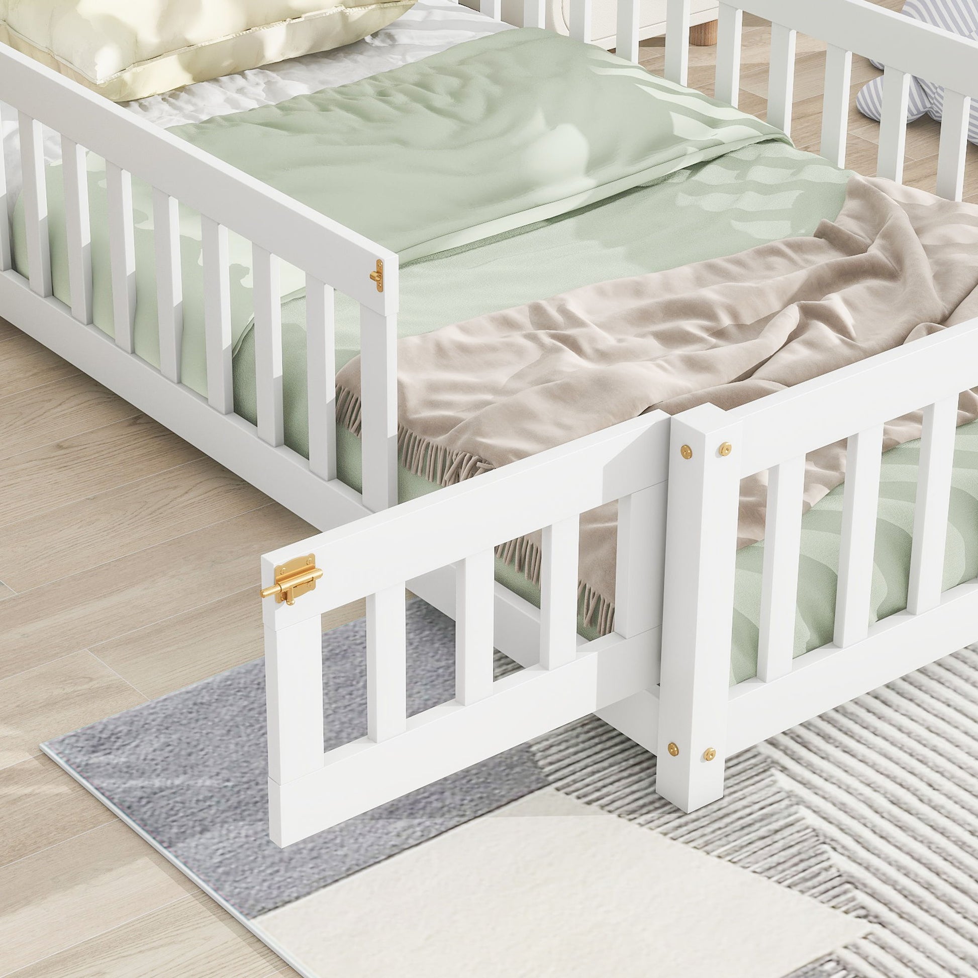 The House-Shaped Headboard Floor Bed With Fence, featuring safety rails and gold hardware, is styled with pastel green bedding and placed on a light wood floor beside a soft gray and cream textured area rug.