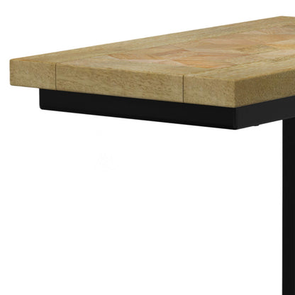 A close-up of the Skyler - Handcrafted C Side Table shows its light natural wood finish and sturdy black metal support underneath.