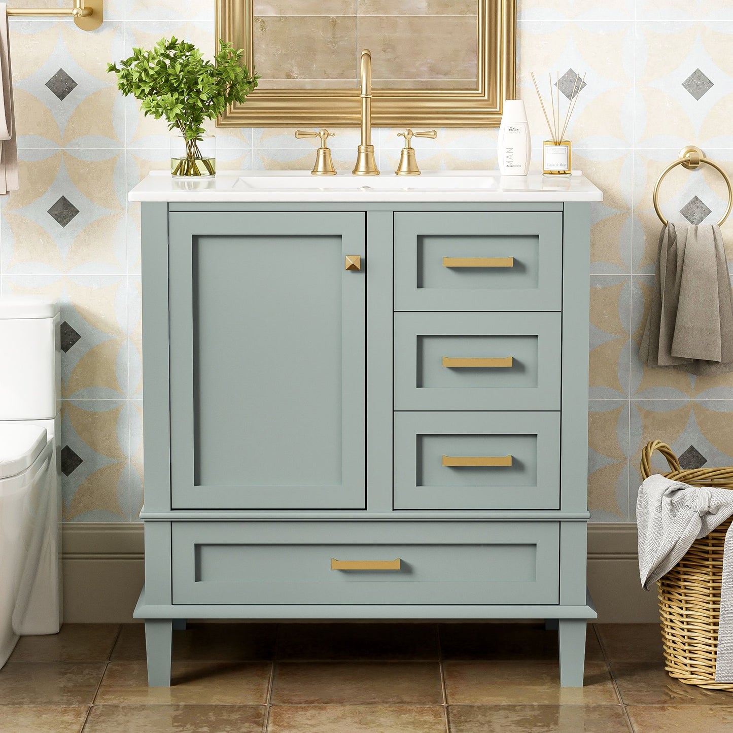 Modern Bathroom Vanity set features a light blue cabinet with gold handles, white countertop, single sink, soft-closing door, and 3 drawers. Decor includes a small plant, soap dispenser, gray towel on ring, and wicker basket with towels on tiled floor.