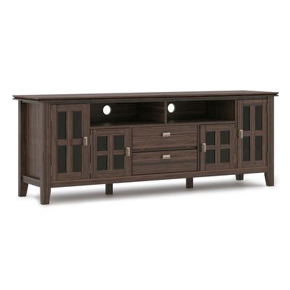 The Artisan TV Media Stand features two central drawers, two open shelves above, and glass-paneled cabinets on each side. The back panel includes circular cutouts for easy cable management.