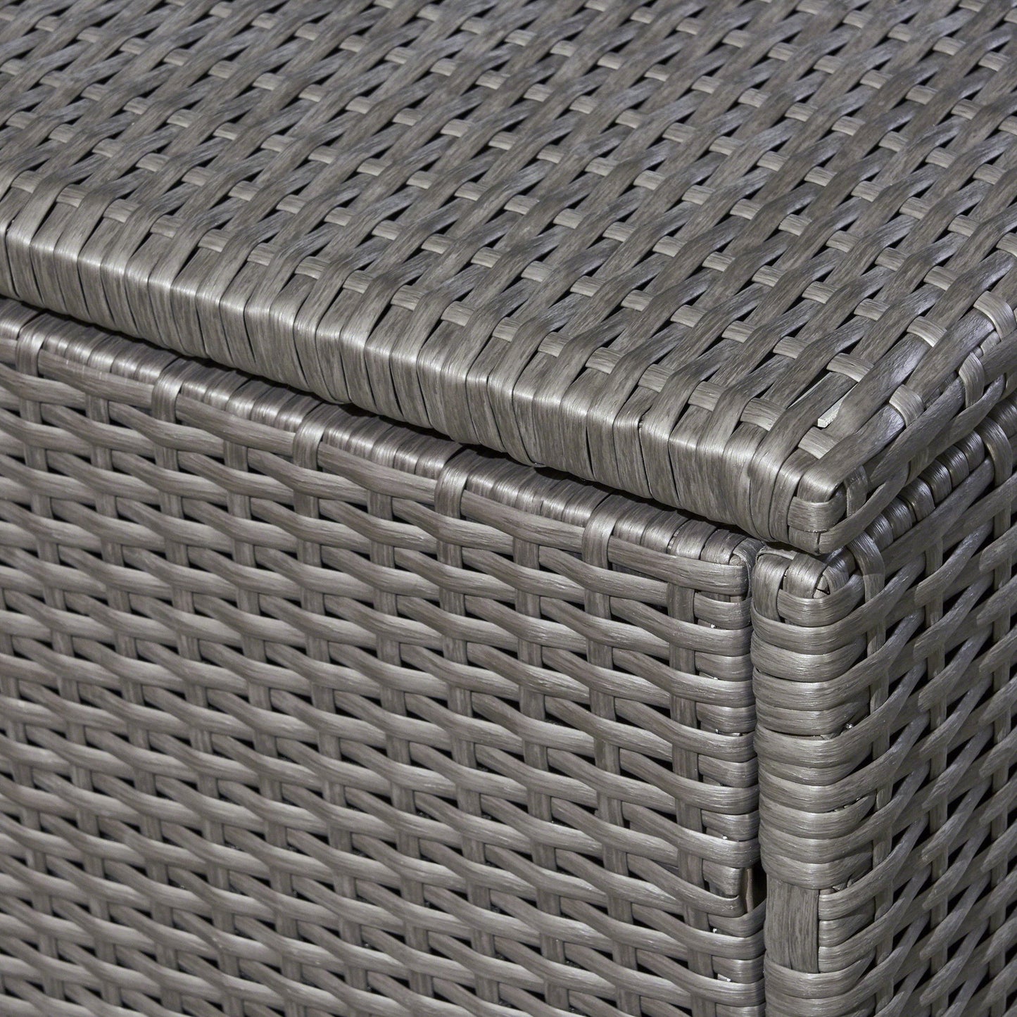 Close-up of the corner of the Santa Rosa - Storage Table, highlighting its gray woven rattan design with detailed interlaced pattern and smooth, rounded edges.