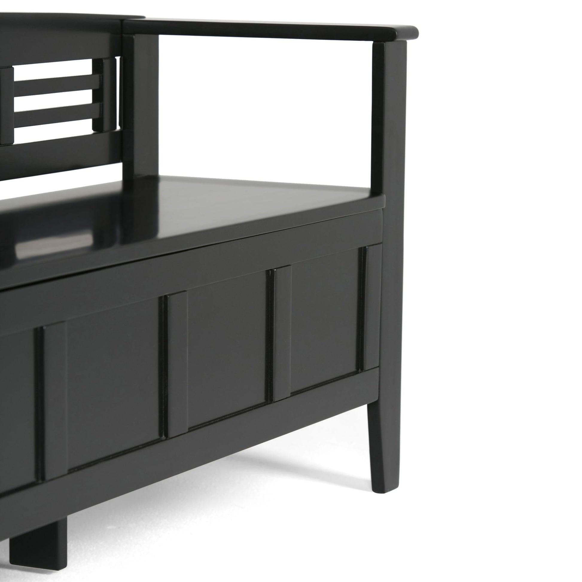 A close-up of the Adams - Entryway Storage Bench Handcrafted, a modern black wooden bench with an armrest, backrest, panel design, and storage compartment under the seat.