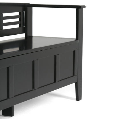 A close-up of the Adams - Entryway Storage Bench Handcrafted, a modern black wooden bench with an armrest, backrest, panel design, and storage compartment under the seat.