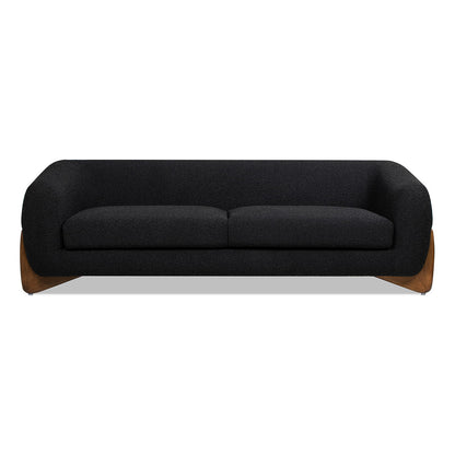The Alpine - Luxurious Upholstery Sherpa Sofa features a modern black design with rounded arms and backrest, two seat cushions, and a wooden base, showcased against a white background.
