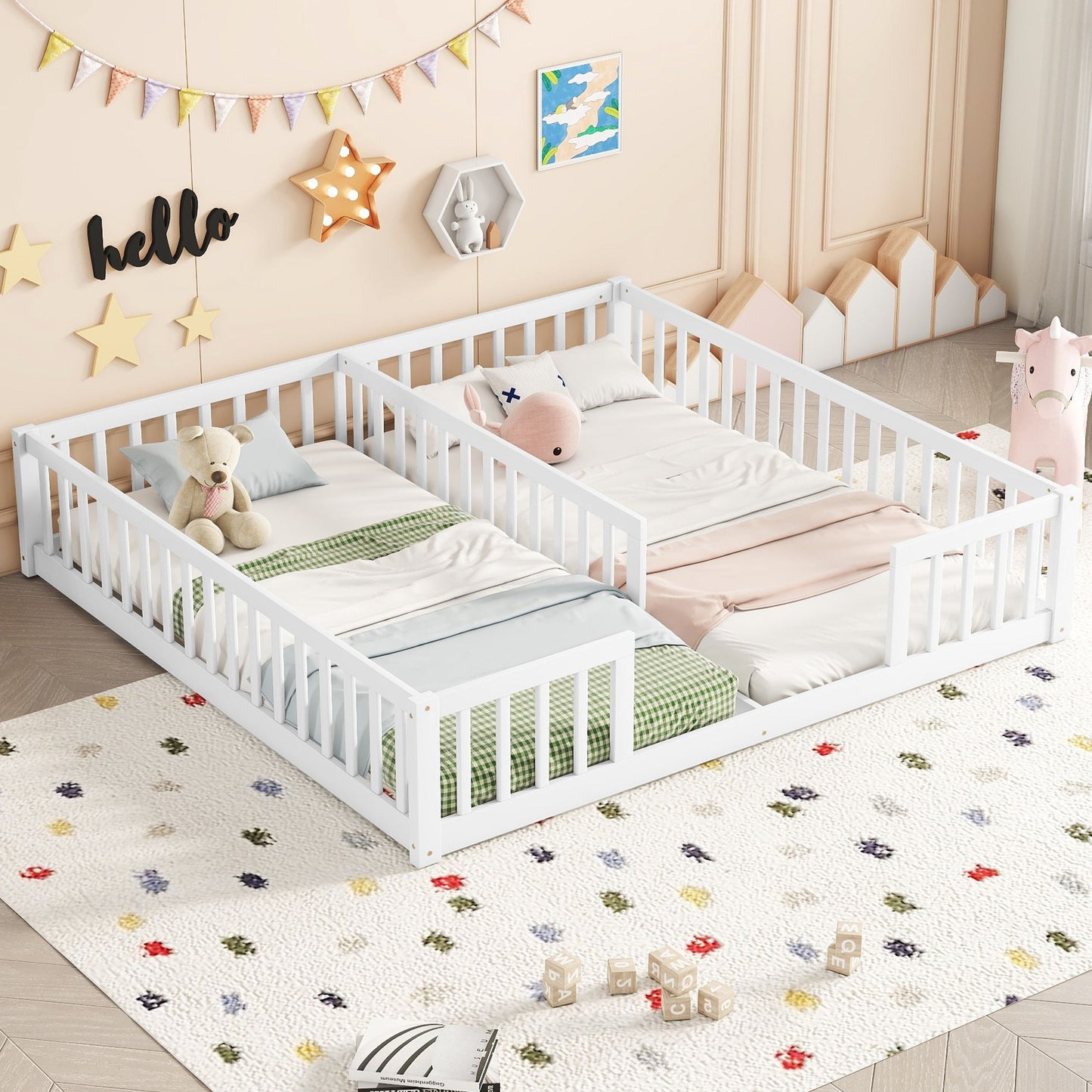 Two Double Floor Beds With Fence and guardrails, set side by side in a pastel-themed kids' bedroom, feature soft blankets, pillows, stuffed animals, a decorative rug, playful wall art, and a plush pink unicorn toy for added coziness.