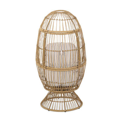 The Patio Swivel Basket Egg Chair With Cushion features a rounded, egg-shaped rattan design with open weaving, a wide base, and a light-colored cushion inside.