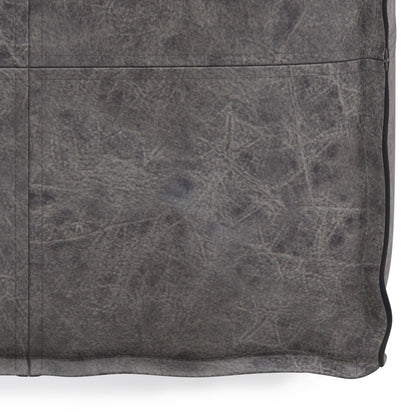 Close-up of the Brody - Versatile Square Pouf, featuring textured, weathered gray leather with visible stitching, subtle creases, and detailed surface patterns for a slightly worn look.