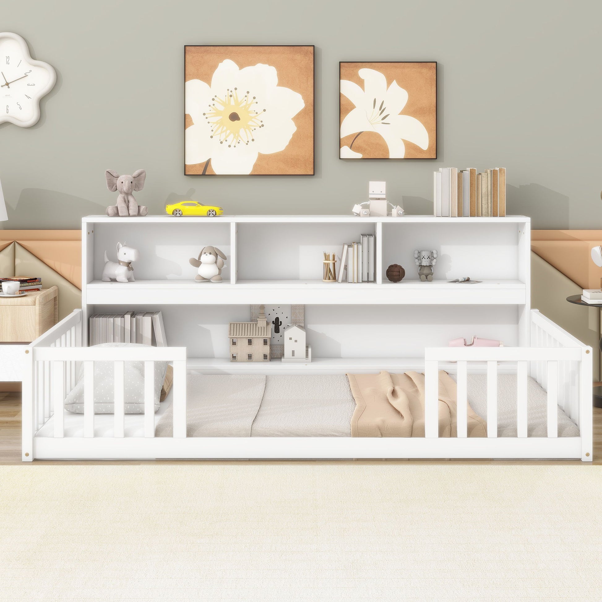 A Floor Bed With Bedside Bookcase, Shelves, and Guardrails is featured in a softly colored room. Books, toys, and decor on the shelving add organization, while neutral tones and plush accents create a cozy space for toddlers.