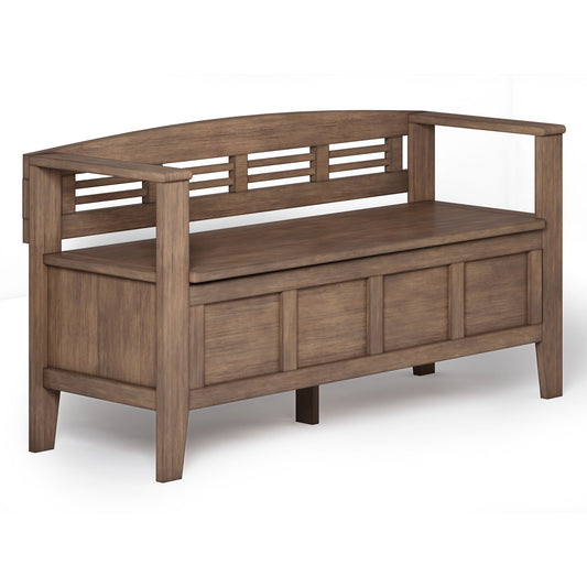 The Adams Entryway Storage Bench features a high backrest, open slats, armrests, hidden storage under the seat, sturdy rectangular legs, and a rustic natural aged brown finish.