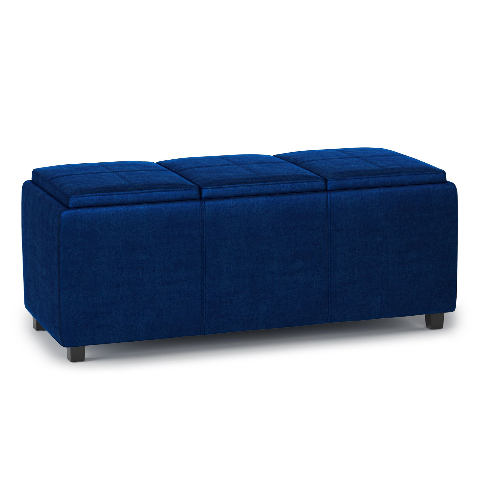 The Avalon Upholstered Storage Ottoman features a rectangular design in deep blue fabric, three cushioned sections, and short black legs, shown against a white background.