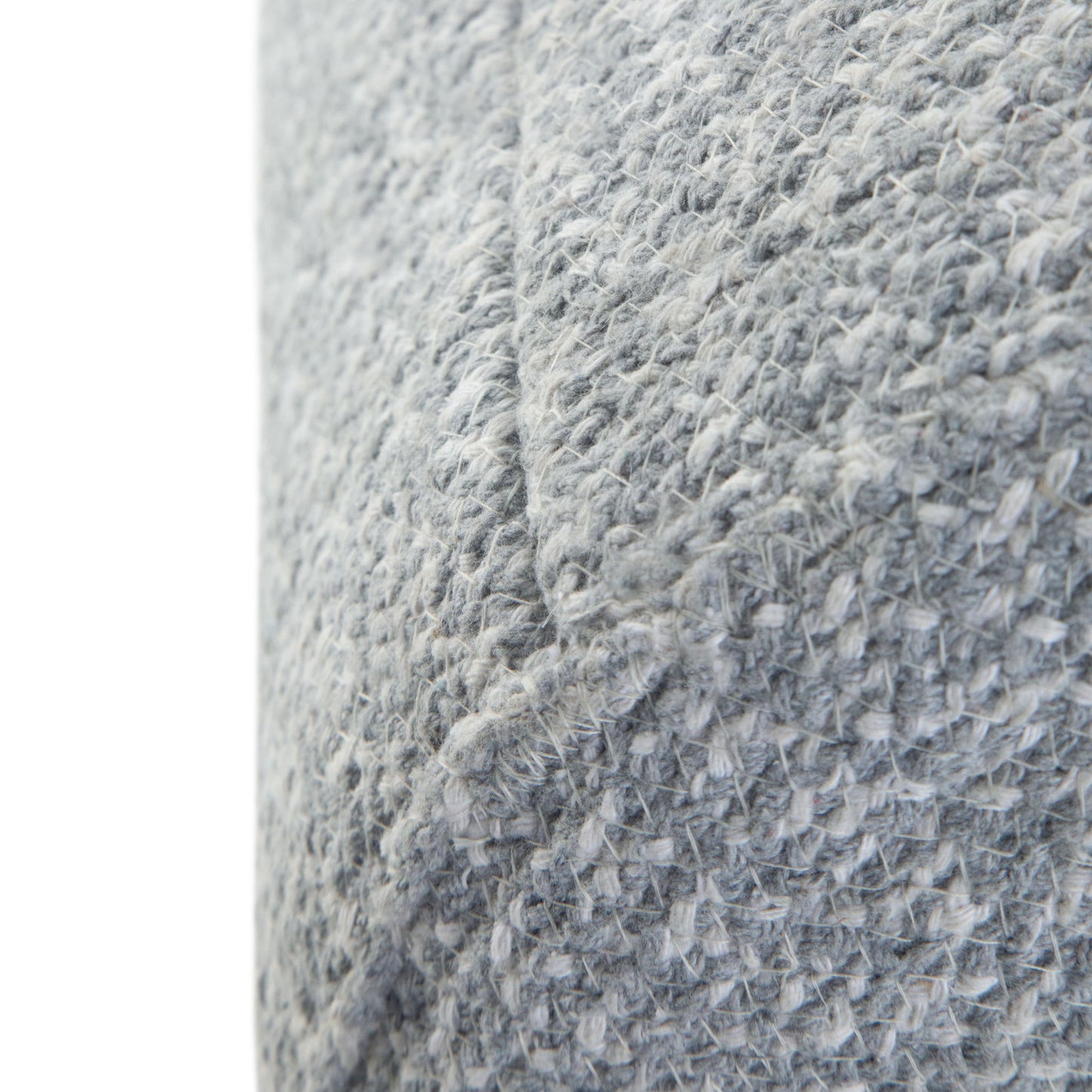 Close-up of the Bayley Versatile Round Braided Pouf’s textured grey woven fabric, showcasing visible stitches and a diagonal seam.