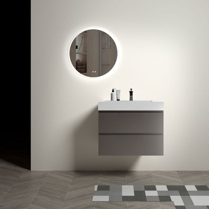 A modern bathroom featuring the Alice floating gray vanity with a spacious one-piece sink basin, topped with two bottles and paired with a round backlit mirror. The floor displays gray and white geometric tile patterns.
