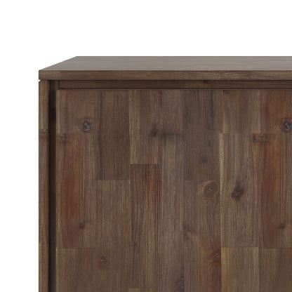 A close-up of the Lowry - Handcrafted Sideboard Buffet shows its natural brown finish, wood grain, and panel details on the top and side, set against a white background.