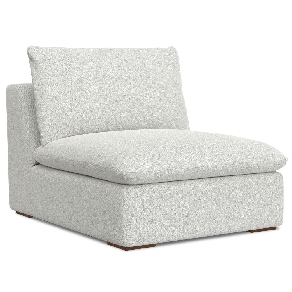 The Jasmine - Handcrafted Sofa And Ottoman features a modern, minimalist design with a thick, light gray cushioned seat and backrest, armless style, and short wooden legs for a contemporary look.