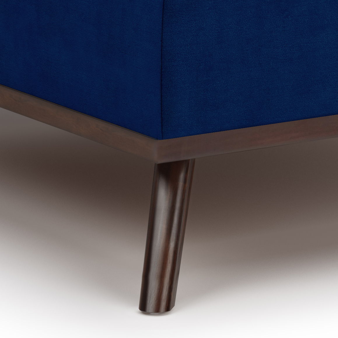 Close-up of the Owen - Multifunctional Square Coffee Table Storage Ottoman, showcasing its blue upholstered finish and dark wooden frame with tapered leg, set against a light-toned background.