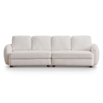 The Paton - Comfortable Sofa is a modern three-seater with plush white upholstery, rounded armrests, and short wooden legs, displayed against a white background.