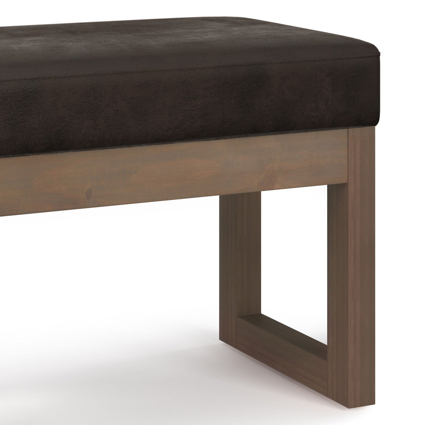 Close-up of the Milltown - Upholstered Ottoman Bench featuring a dark brown cushioned seat and wooden legs in a rectangular, open-frame design. Set against a plain white background.