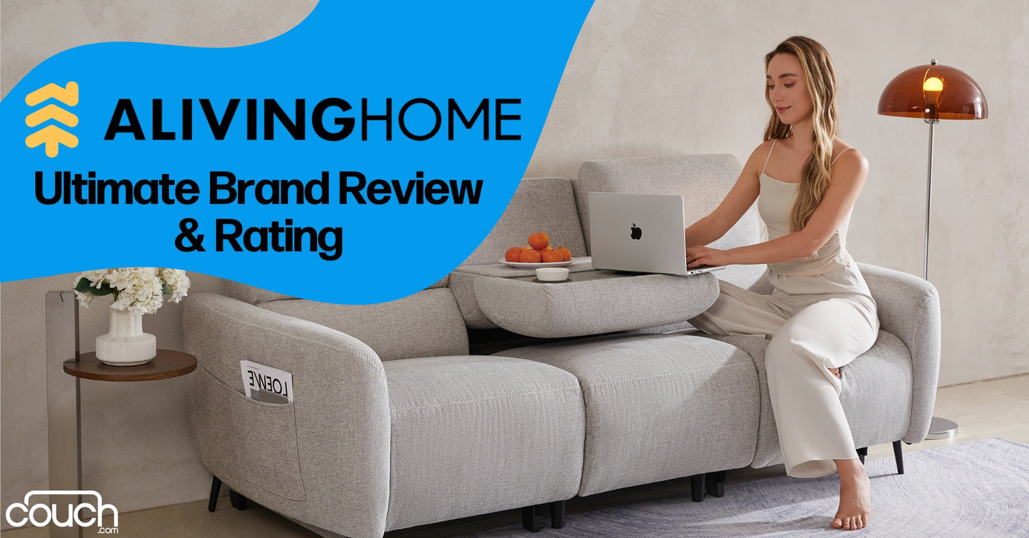 A woman sits on a light gray couch using a laptop. The couch has a fold-out table with oranges. A floor lamp is in the background. Text reads "ALIVINGHOME Ultimate Brand Review & Rating" and "couch.com" is in the corner.