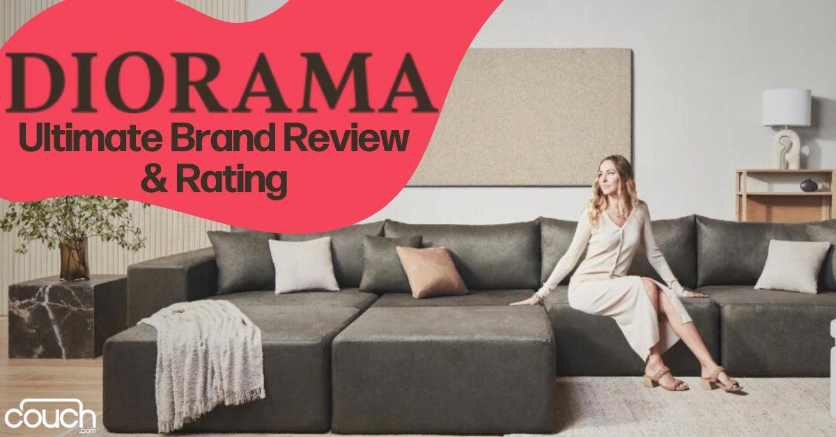 A woman sits on a large, dark-colored sectional sofa in a modern living room. The text reads "Diorama: Ultimate Brand Review & Rating." The room has a minimalist design with a neutral color palette and decorative pillows.