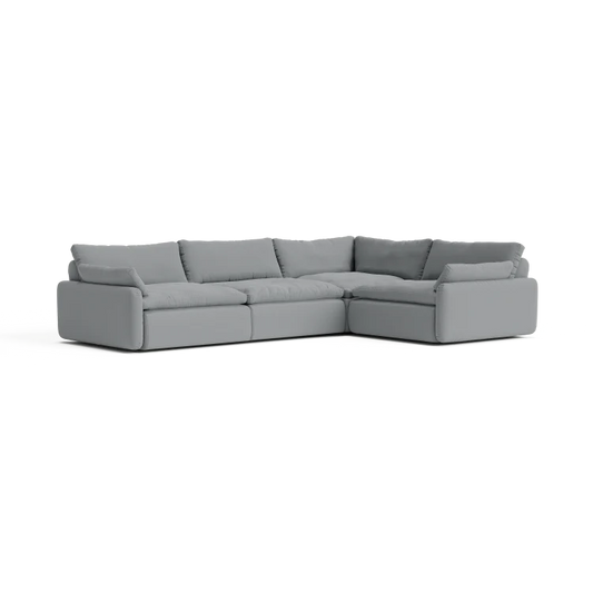 The Sink Down Sectional is a large, gray, L-shaped sofa with thick cushions and a modern design, placed against a plain background.