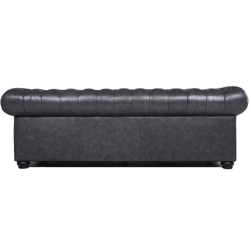 The image features the back view of the Birch Lane Freddie 95'' Leather Sofa, a black, tufted Chesterfield design with rolled arms and a low back. The texture looks smooth, and it stands on small, rounded wooden legs.