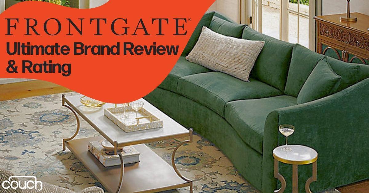 A green velvet sofa with multiple cushions sits in a bright and spacious living room. A coffee table with books and decor is in front of the sofa, and a large window is in the background. Text on a red shape reads "Frontgate: Ultimate Brand Review & Rating.