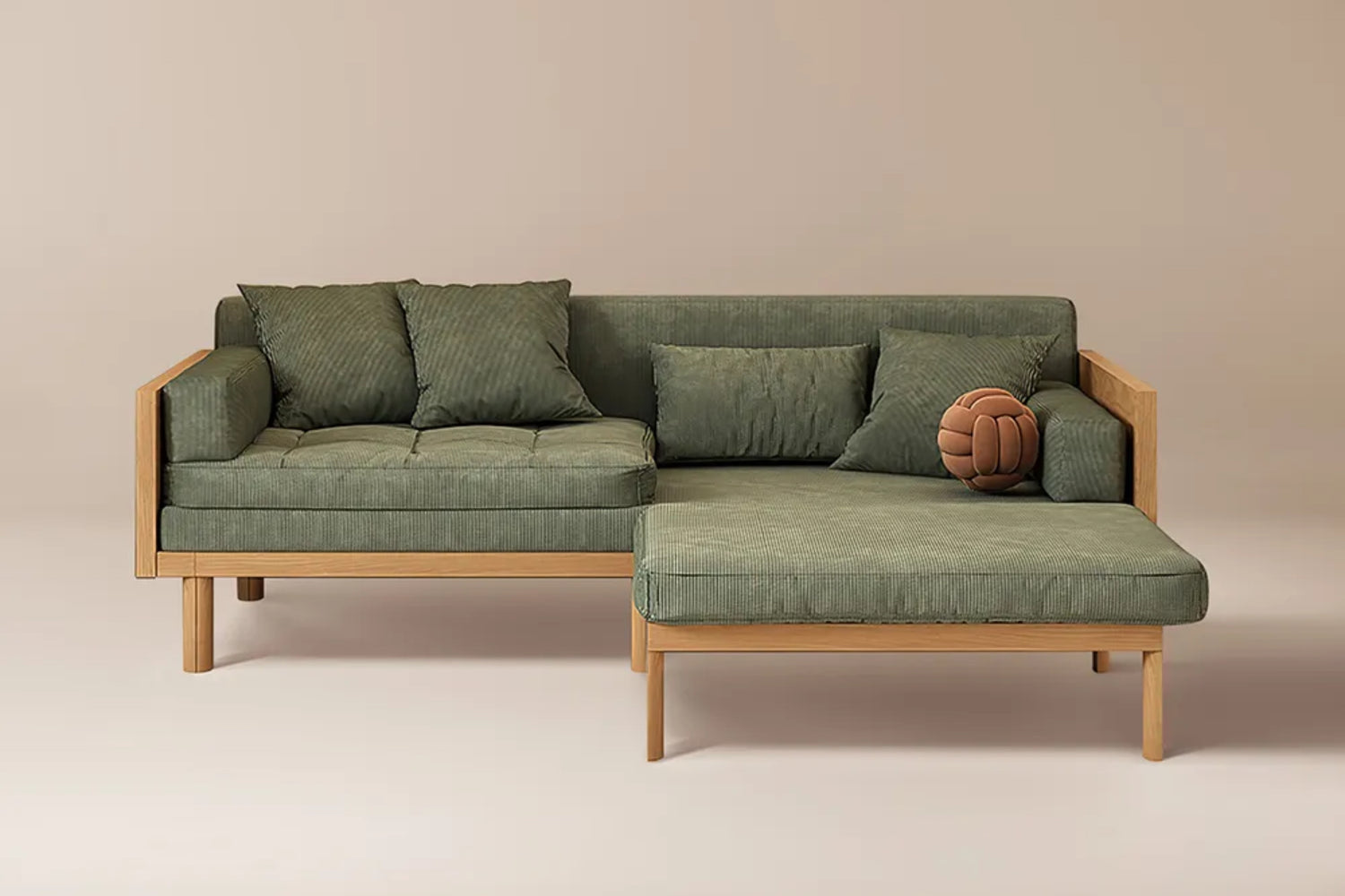 A green L-shaped sofa with wooden legs and two large cushions is set against a beige background. A vintage brown soccer ball rests on the sofa's corner, adding a unique decorative touch.