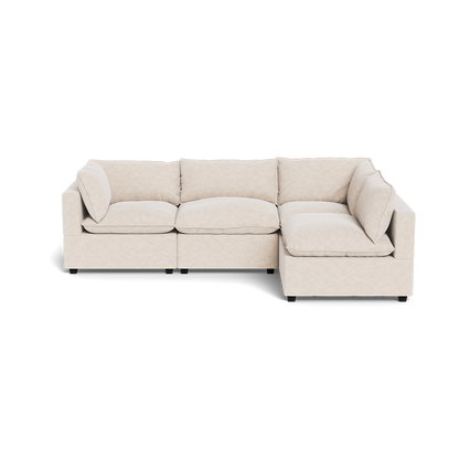 The Kova Pillow Cushion L-Shape sectional, featuring plush cushions and armrests in beige, is displayed against a white background.