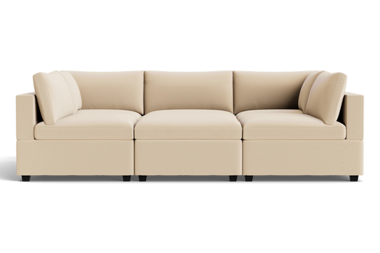 The Kova Box Cushion Pit is a modern beige sectional sofa with three seat cushions, six back cushions, and square arms, set against a plain black background.