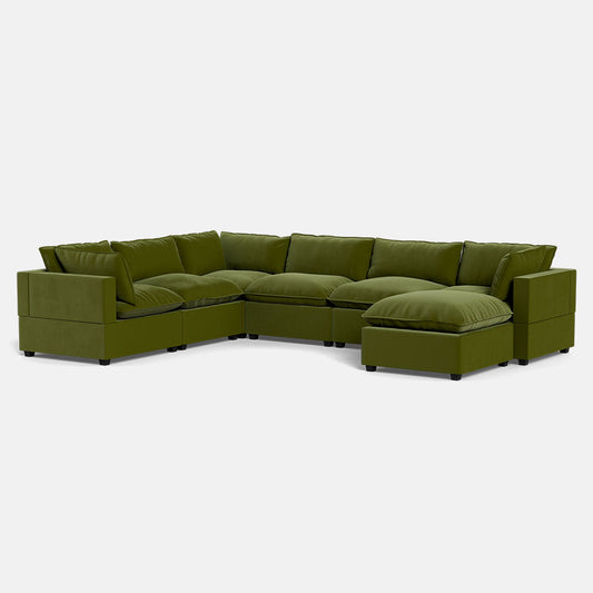 The Kova Pillow Cushion Grand Corner + Ottoman is a spacious, contemporary L-shaped sectional with a chaise lounge, wide armrests, thick cushions, and stylish olive green upholstery.