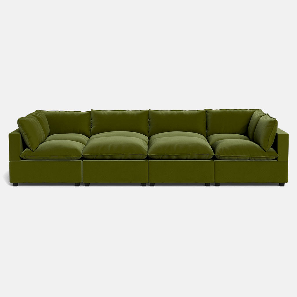 The Kova Pillow Cushion Grand Pit is a modern, modular green sofa with four large, plush seat cushions and matching back cushions, shown against a plain white background.