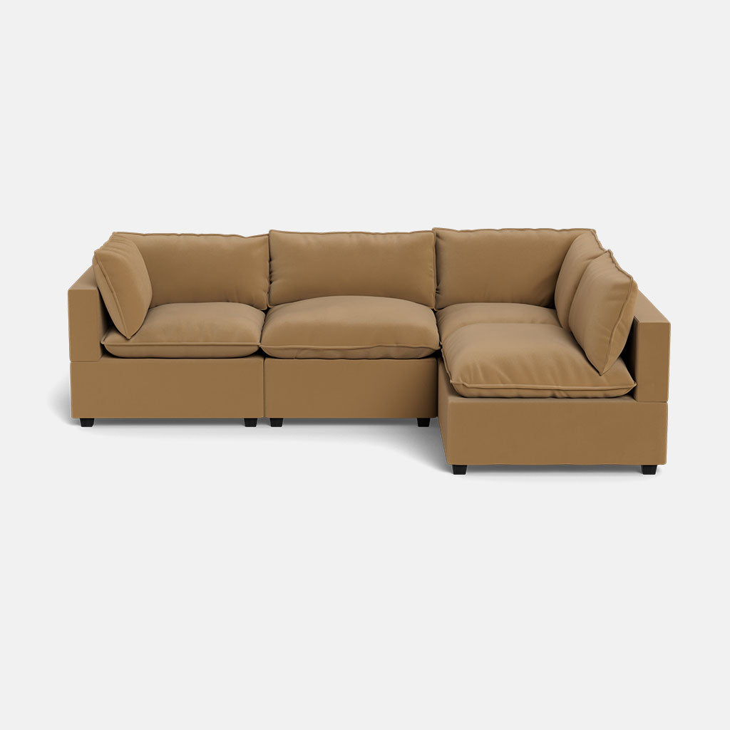 The Kova Pillow Cushion L-Shape sectional sofa features modern, clean lines and tan cushions, displayed against a plain white background.