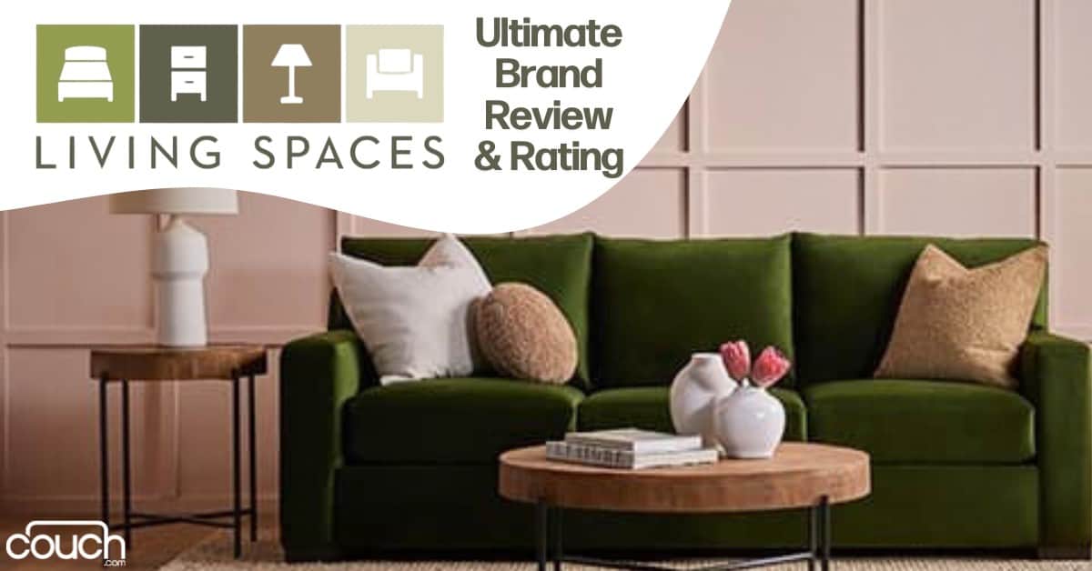 An olive green sofa is placed against a blush pink paneled wall. There are two round wooden coffee tables in front of it, one with a white vase holding pink flowers. A wooden side table with a white lamp is beside the sofa. Text reads "Living Spaces: Ultimate Brand Review & Rating.