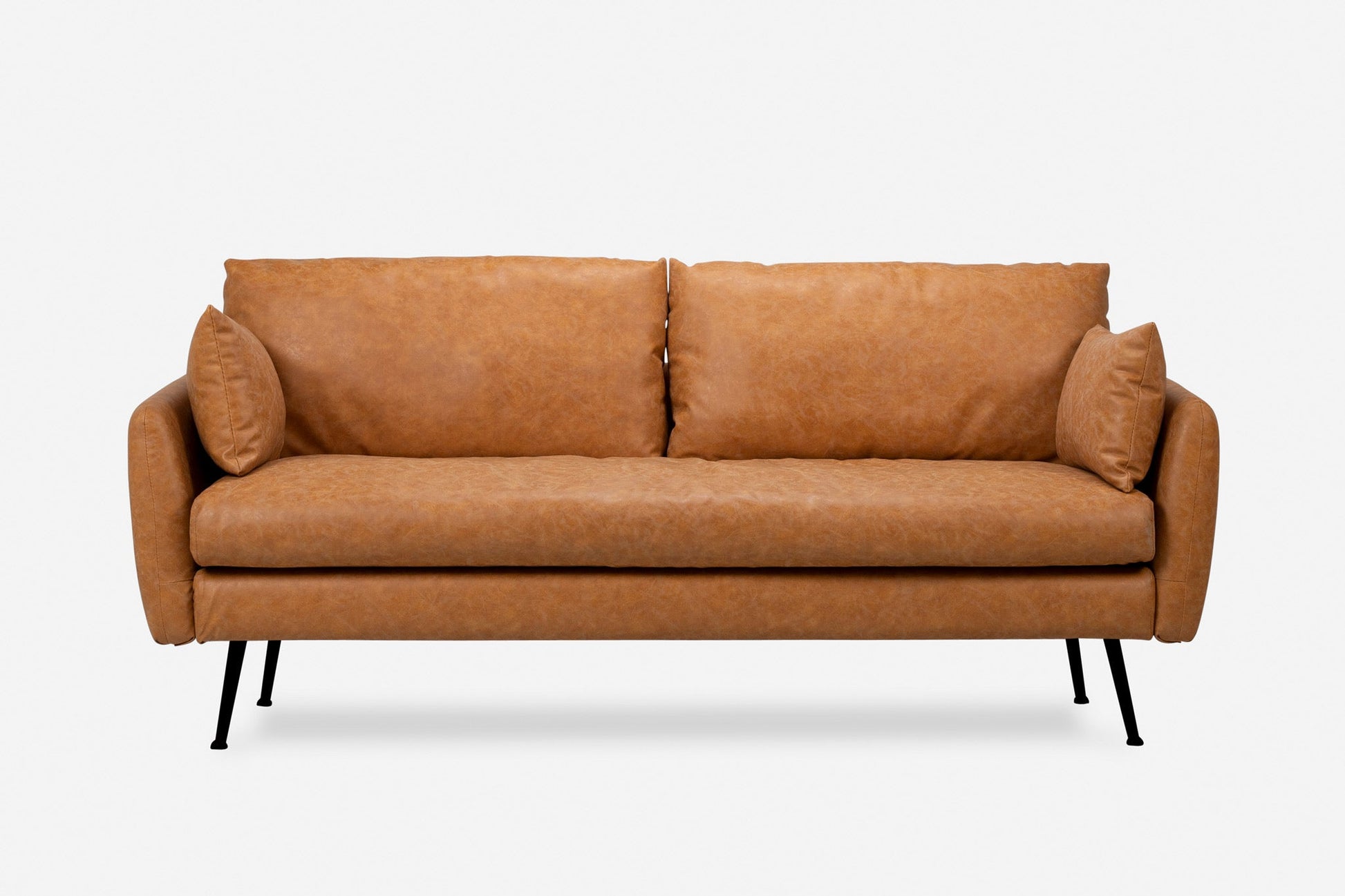 The Park Sofa features a modern design with light brown leather upholstery, slim black metal legs, two large seat cushions, two back cushions, and small side pillows, set against a plain white background.
