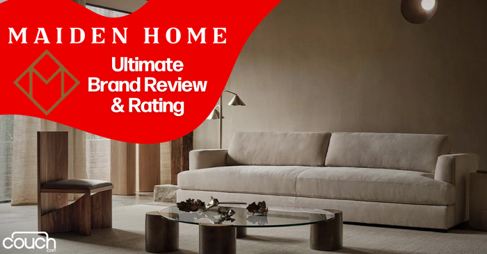A modern living room with a beige sofa, round coffee table, and abstract decor pieces. A red graphic overlay displays the text: "Maiden Home Ultimate Brand Review & Rating.