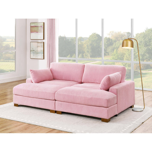 The spacious, light-filled living room showcases the Etta Avenue Mordecai 90'' Square Arm Sofa, elegantly positioned on a beige rug. A gold floor lamp stands beside this large, pink sectional sofa, while expansive windows offer views of trees and greenery outside.