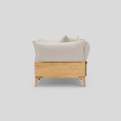 Side view of the Bluff Loveseat, featuring a modern design with a light wooden frame and light gray cushions, set against a plain background.