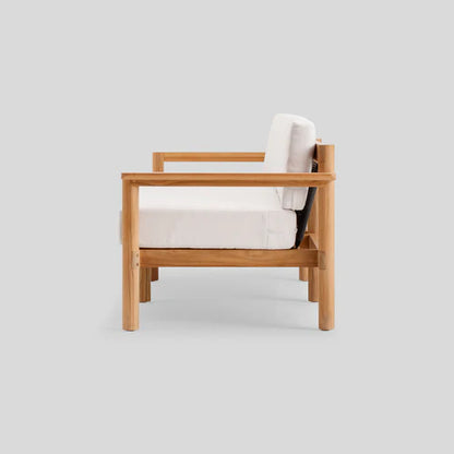 Side view of the Haven Sofa, showcasing a wooden frame with white cushions. The sofa features a simple, modern design with clean lines and a natural wood finish against a plain gray background.