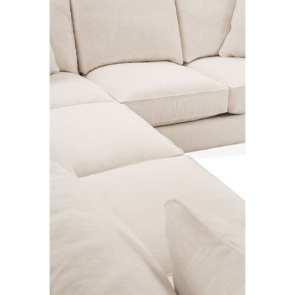 Close-up of the Brooke 6-Piece Left-Facing Sectional in a cream color, featuring plush cushions and a soft fabric texture, with a focus on the corner where two sections connect. The image showcases the smooth and inviting surface, emphasizing the sectional's modern design.