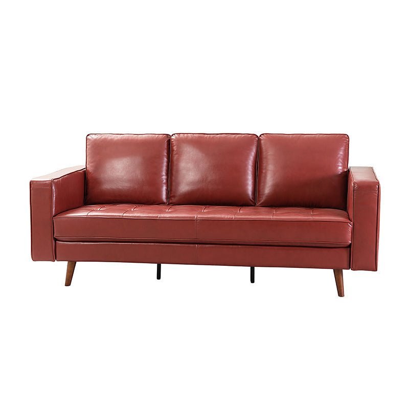 The Anatole Leather Sofa is a contemporary piece featuring three seat cushions and angled wooden legs, all presented in a rich red leather against a plain white background.