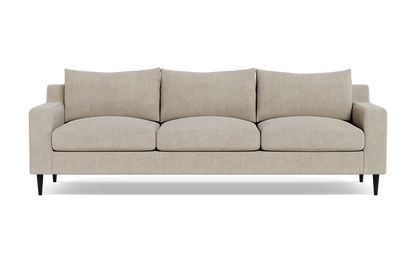 The Sloan Custom 3-Seat 95" Sofa is a beige, three-seater piece featuring clean lines and a modern design. It includes three large seat cushions and three matching back cushions. The sofa is styled with short, black legs and embodies a minimalist aesthetic, perfect for contemporary interiors.