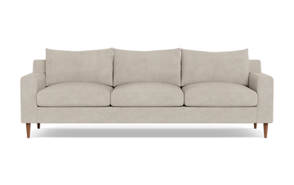 The Sloan Custom 3-Seat 95" Sofa is a modern beige sofa featuring streamlined, rectangular cushions and slim wooden legs, positioned against a plain black background.