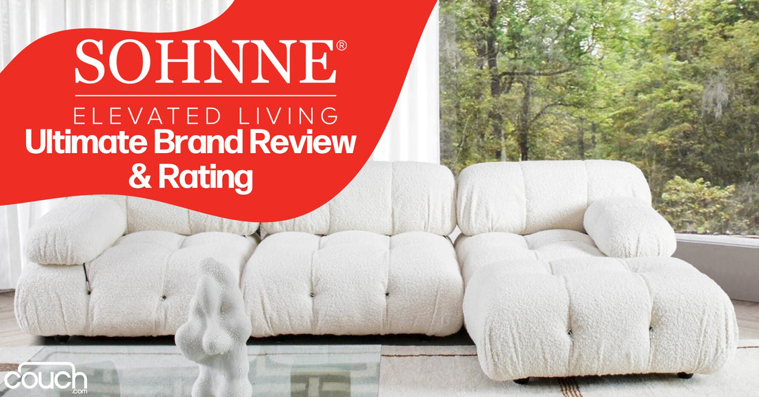 A plush, white sofa is positioned in front of large windows with views of a lush forest. The text reads "SOHNNE Elevated Living Ultimate Brand Review & Rating" over a red banner. A decorative, abstract statue sits on a glass table beside the sofa.