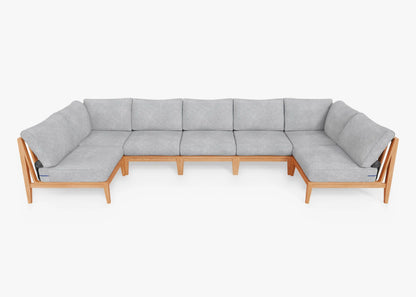 The Teak Outdoor U Sectional - Seven Seat is a spacious, modern piece with a sleek wooden frame and light gray cushions. Its minimalist design offers plenty of seating, set against a plain white background.